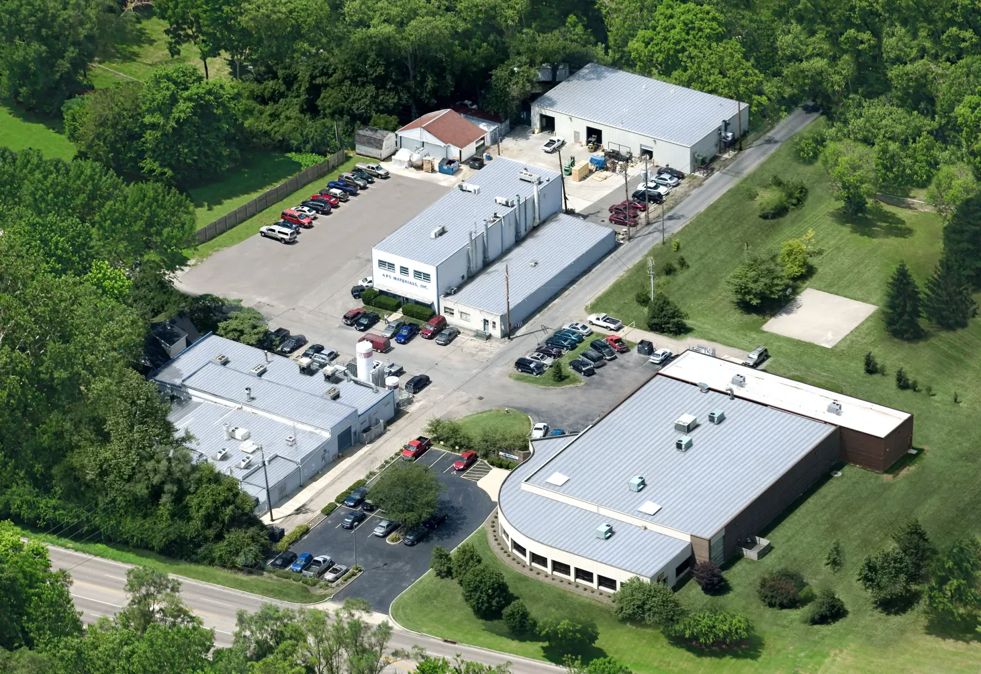 Aerial view of the APS Materials buildings in Dayton, Ohio, on both sides of the street