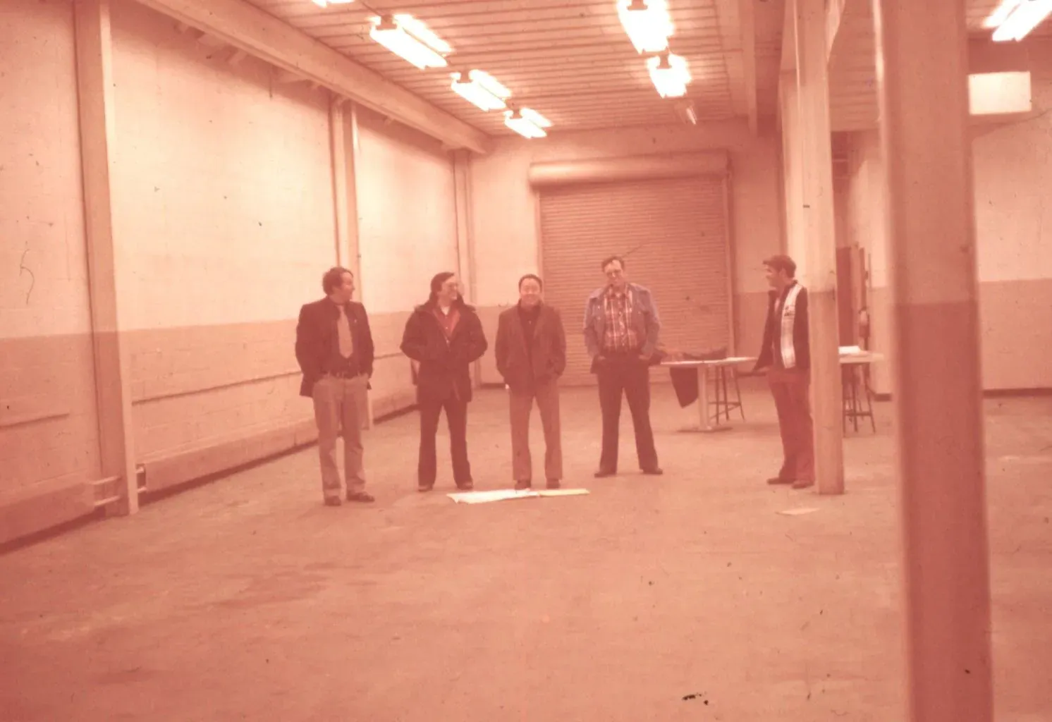 The four APS Materials engineers, Doug, Mike, Joe and Gene, standing with foreman Bill Grizzle in an early Dayton building