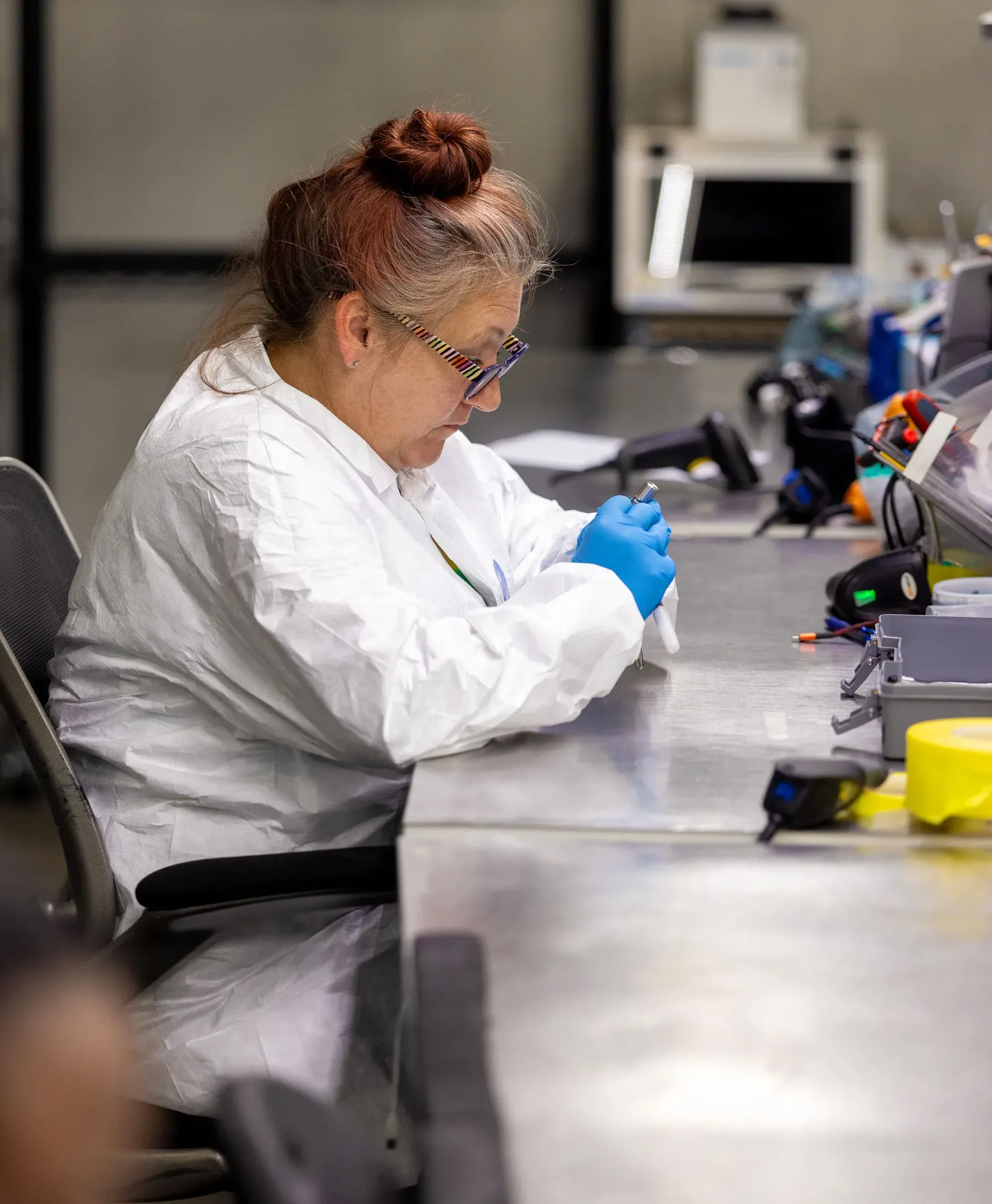 Technician working at a dedicated medical device workstation