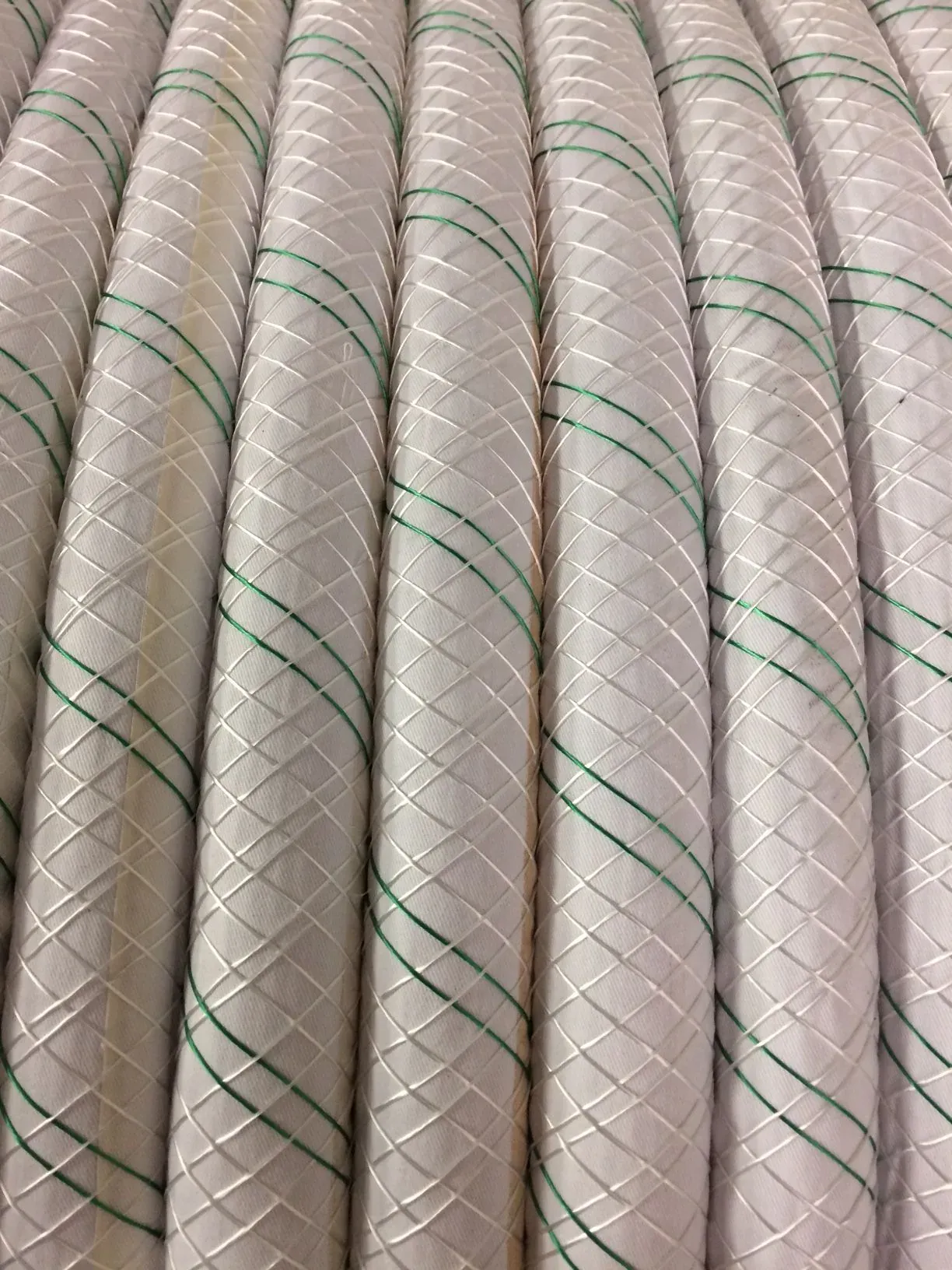 Braided AC mitigation grounding conductor coiled on a reel
