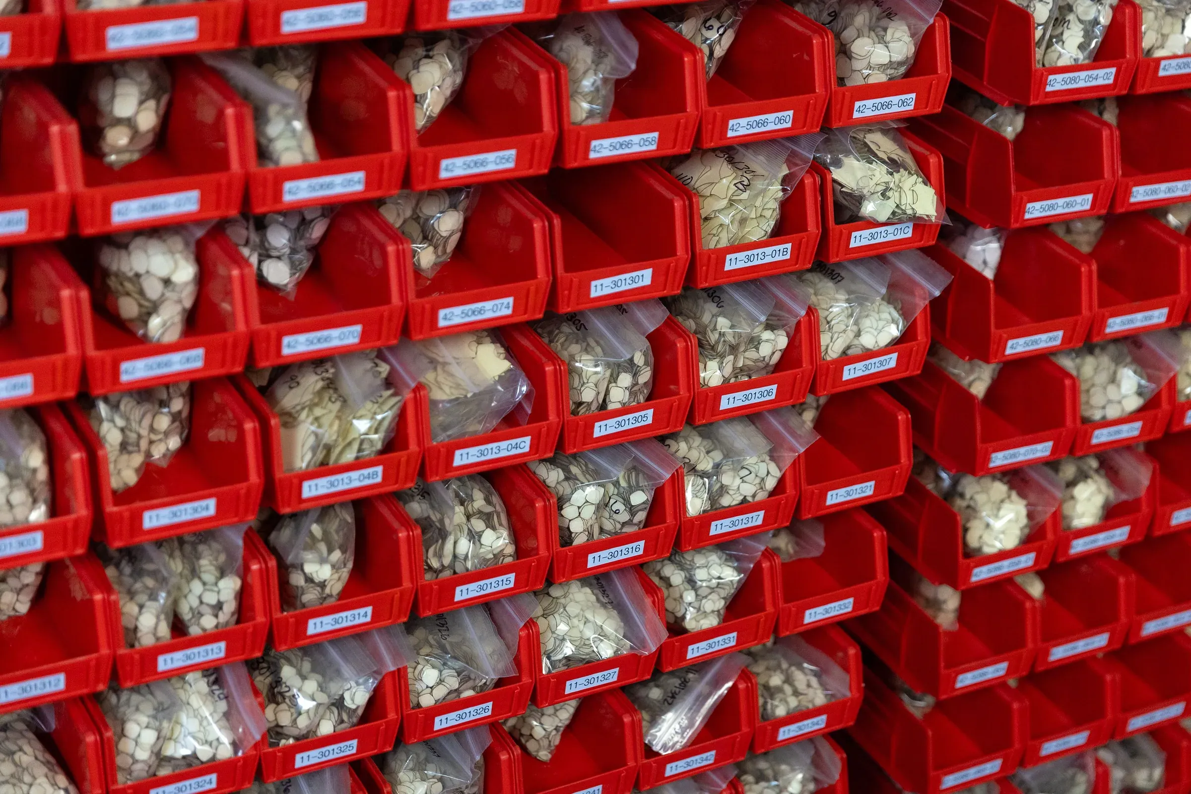 Bin wall of pre-cut masking components staged for production