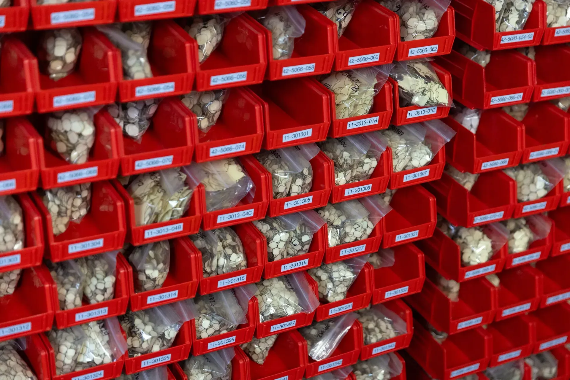 Bin wall of pre-cut masking components staged for production