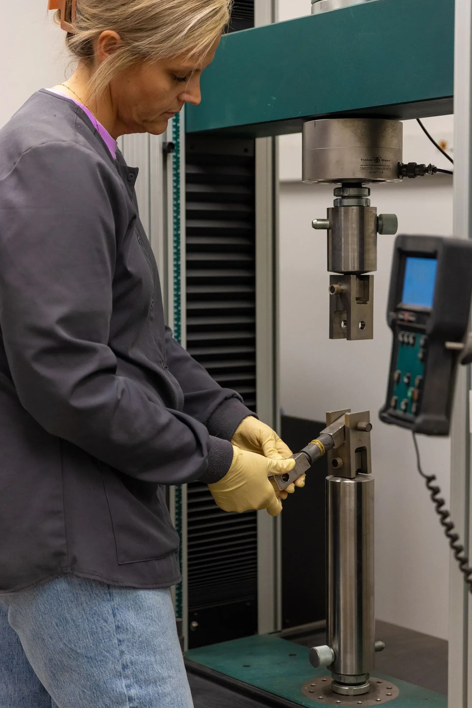 Lab technician running a coating bond strength test