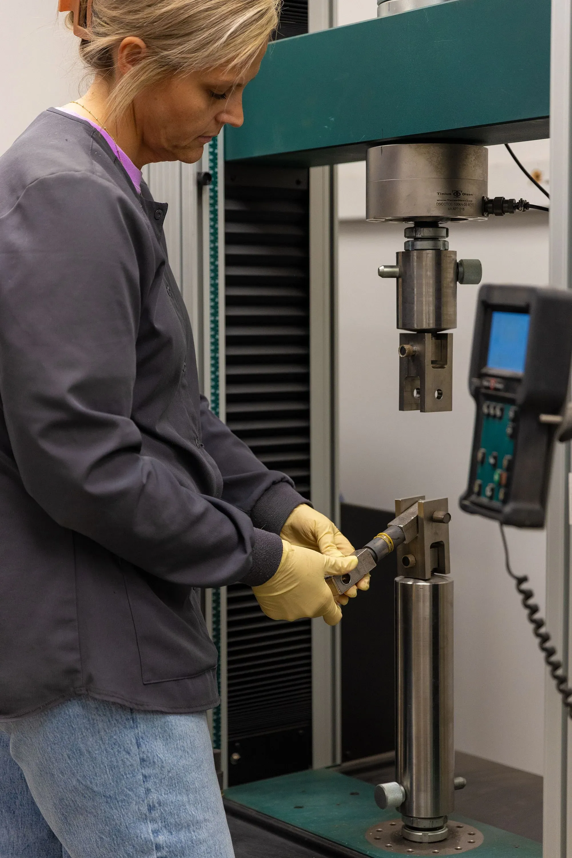 Lab technician running a coating bond strength test