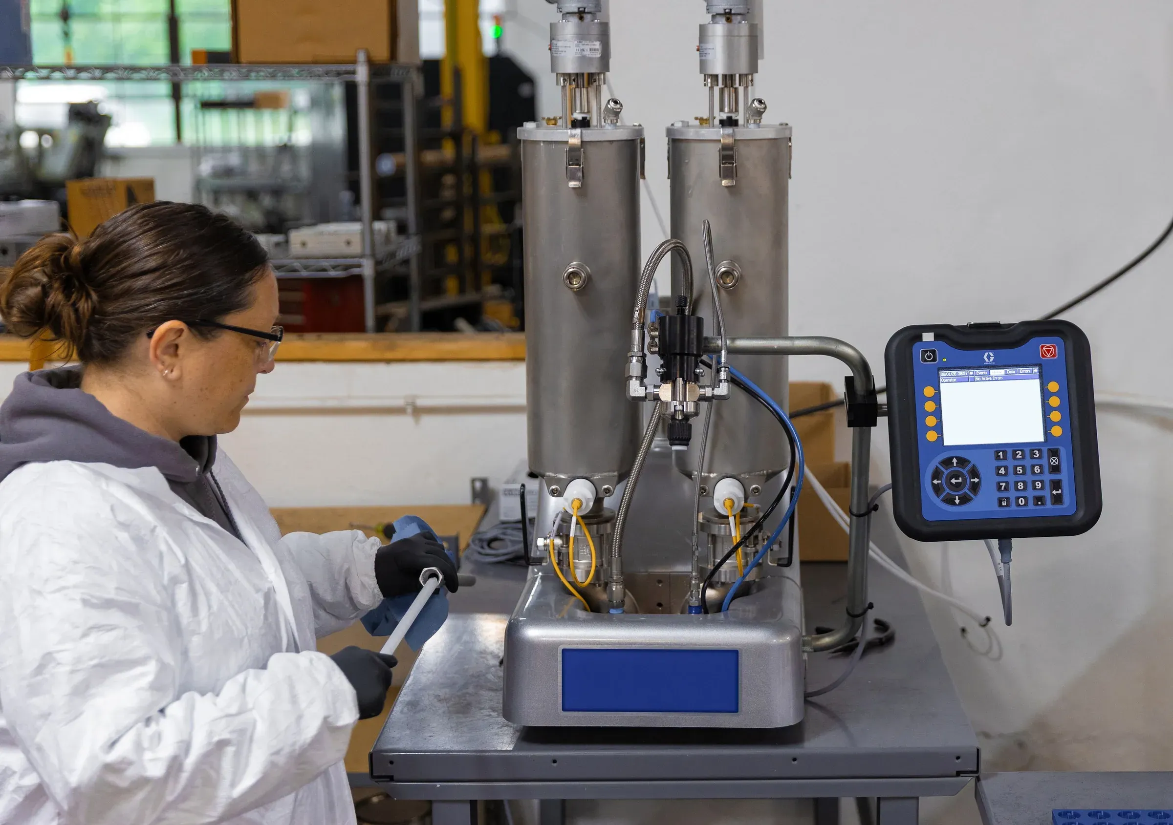 Technician operating a two-component silicone meter-mix dispensing unit