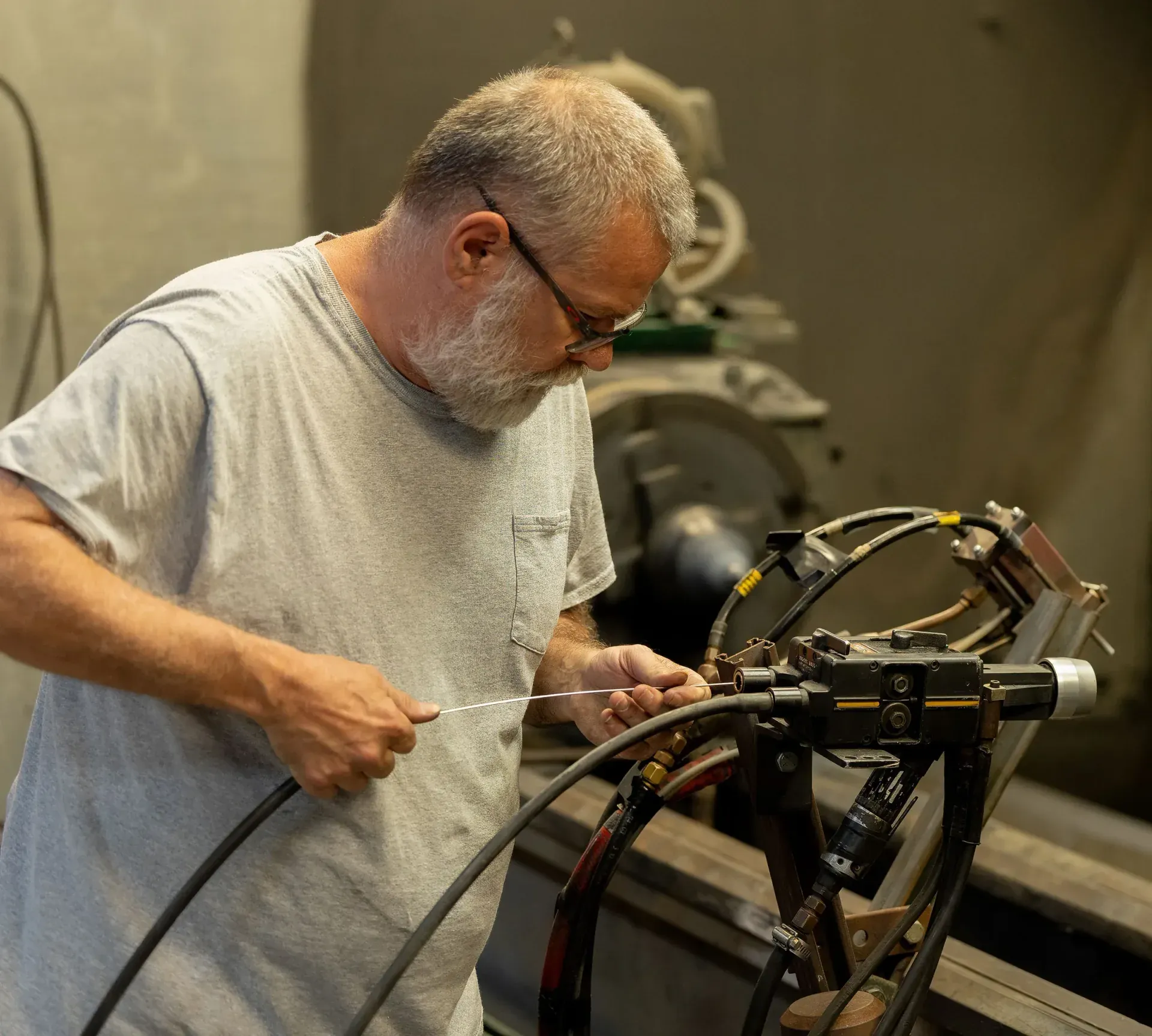 Operator setting up a twin-wire arc spray gun