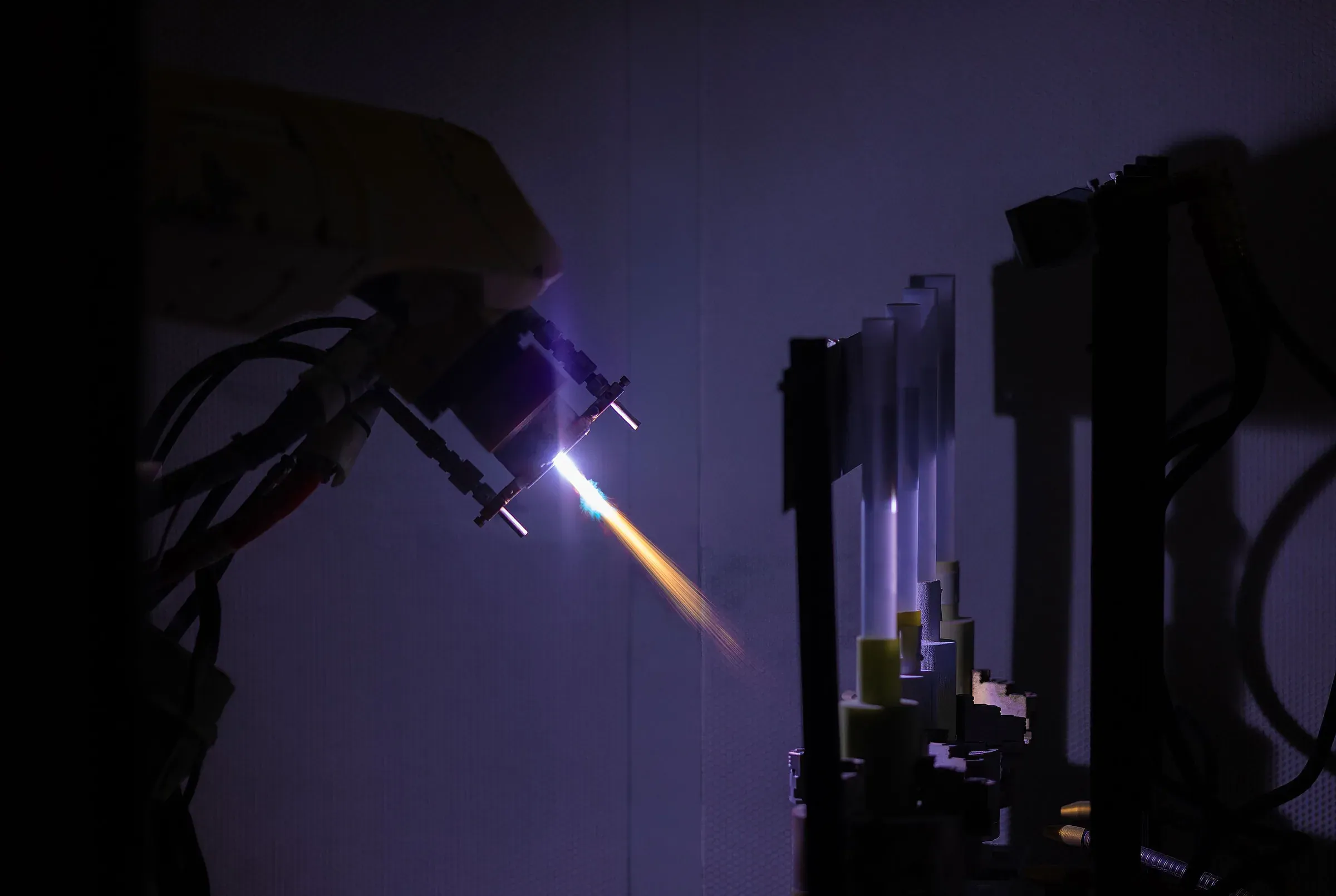 Vacuum plasma spray process in a controlled chamber