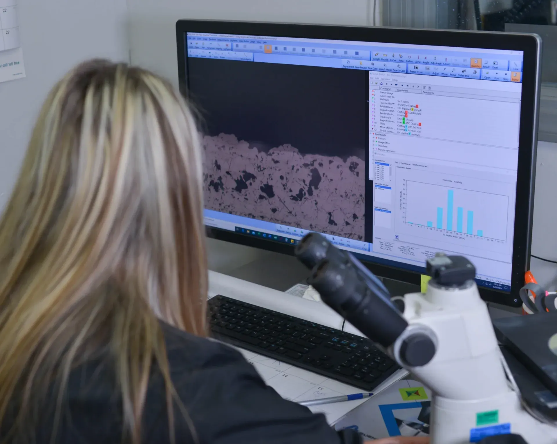 Metallurgical technician measuring coating thickness on a micrograph