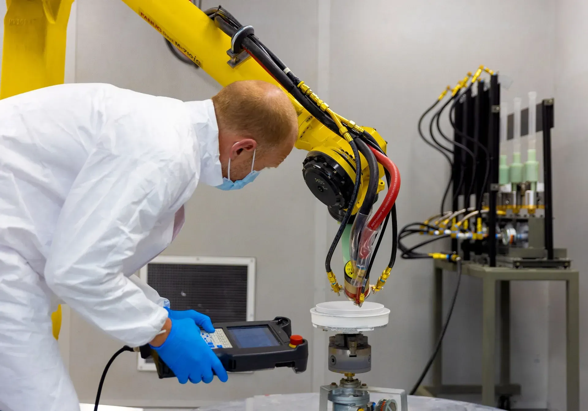 Engineer teaching a robot path for a new coating program