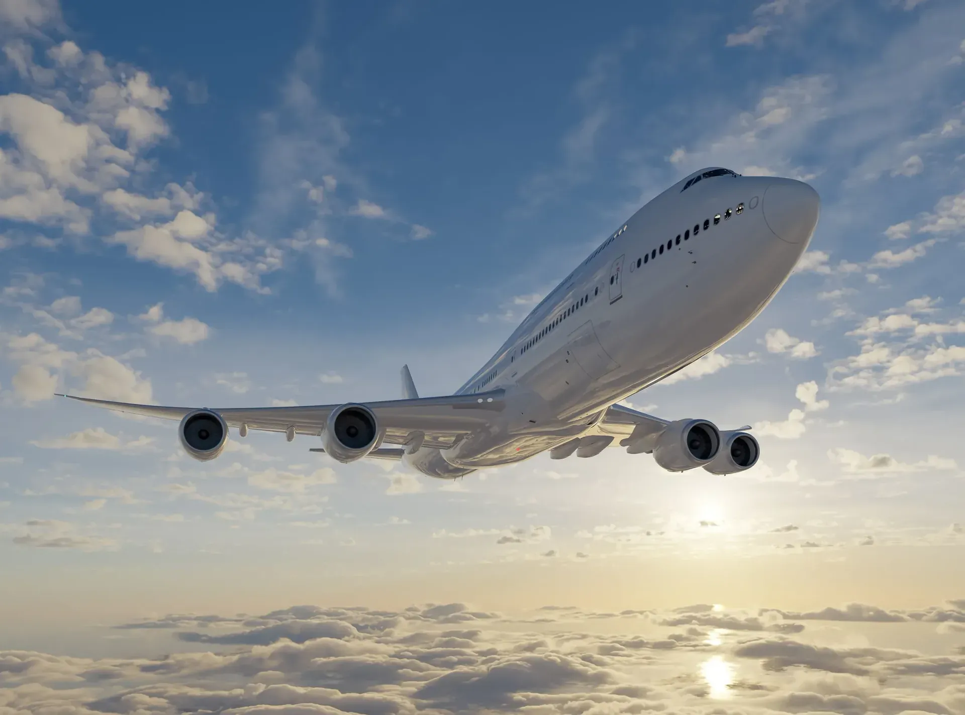 Commercial jet airliner in flight above the clouds at sunset
