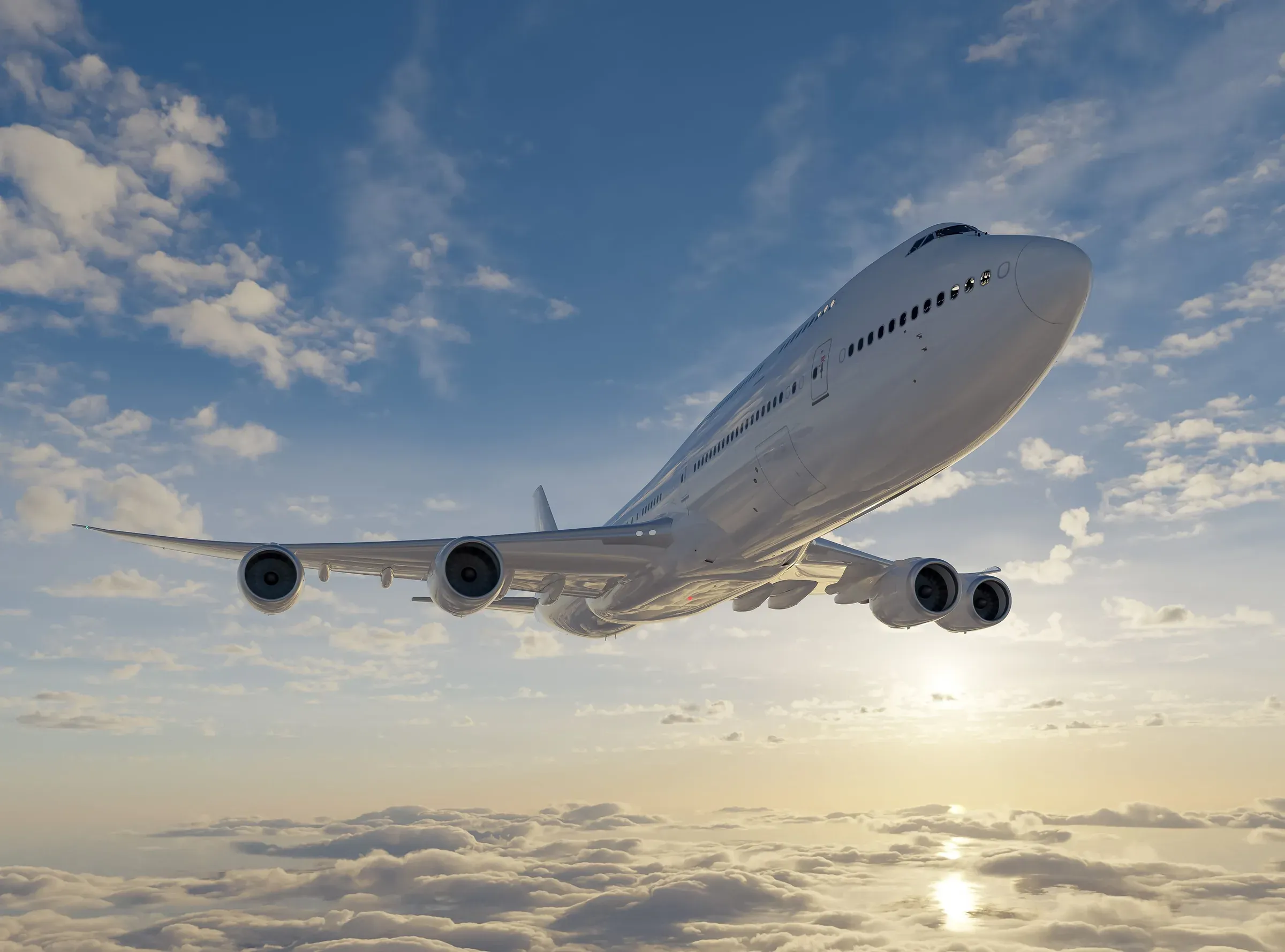 Commercial jet airliner in flight above the clouds at sunset