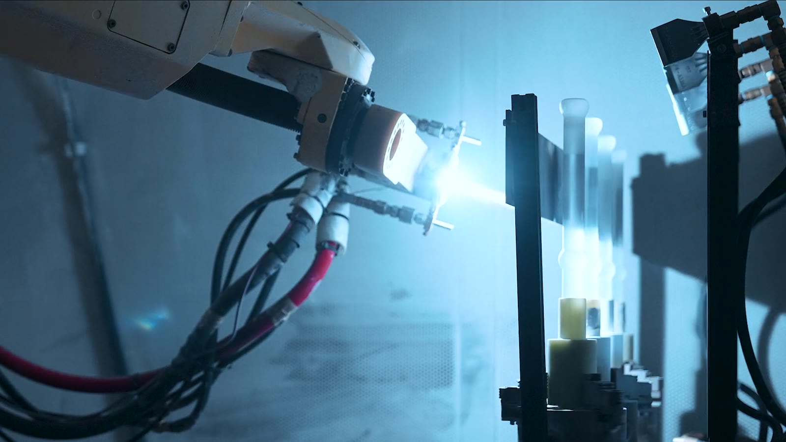 Robotic thermal spray cell coating a component at APS Materials